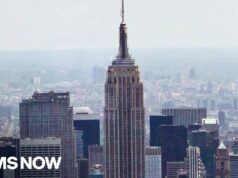 Two people climb to the top of the Empire State Building